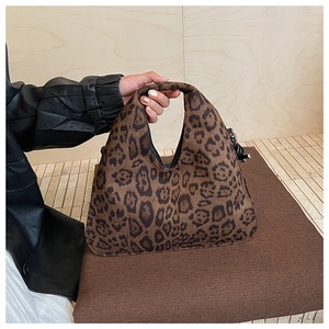 Detail of leopard print hobo bag showing high-quality suede texture and metal buckle accents