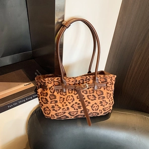 Fashionable leopard print faux suede tote bag with brown straps and metal buckle detail