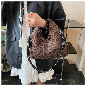 Detail of leopard print handbag with knotted rope handle and silver metal hardware