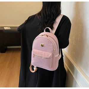 Close-up of pink leopard print mini backpack with elegant gold metallic hardware details