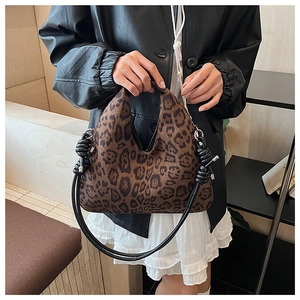 Detail view of the leopard print hobo bag with a black leather knotted handle detail