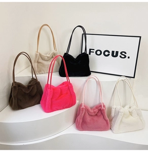 Multiple colors of plush faux fur shoulder bags displayed on minimalist white stairs
