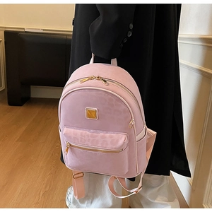 Close-up of pink leopard print backpack with premium gold metal zipper and faux leather
