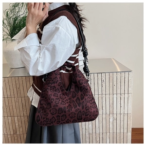 Close-up of vintage leopard print hobo bag with unique knot shoulder strap and velvet texture