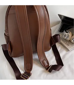 Detail view of adjustable faux leather straps on a vintage leopard print backpack