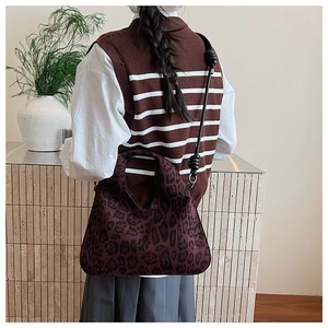 Detail of vintage leopard print tote bag with cutout handle and slim shoulder strap