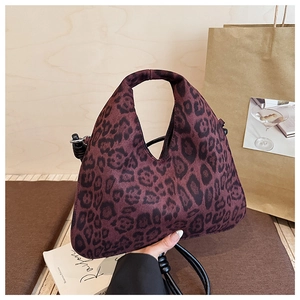 Detail of red leopard print faux suede tote bag with integrated handle and shoulder strap
