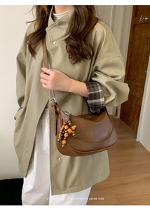 Retro brown half-moon crossbody bag with decorative wooden beads and adjustable strap
