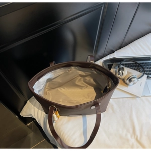 Detailed interior of a deep brown tote bag with large capacity and inner zipper pocket