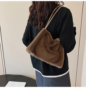 Brown faux fur tote bag with long plush texture worn by model for winter outfit look