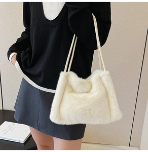 Detail of soft white faux fur tote bag with thin double straps and plush texture