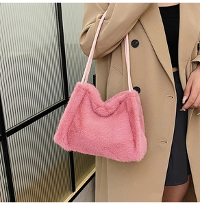Detail of pink faux fur shoulder bag featuring soft texture and minimalist rectangular shape