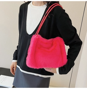 Detailed texture of vibrant pink faux fur shoulder bag with soft plush finish and straps