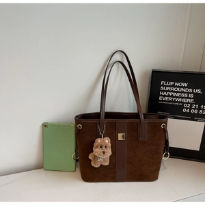 Fashionable dark brown suede tote bag with leather patchwork and plush puppy pendant