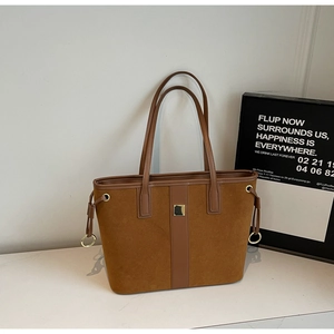 Fashionable brown suede and leather tote bag with elegant gold buckle and shoulder strap