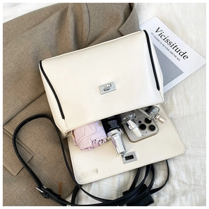 Internal view of white leather bucket bag showing space for phone and umbrella