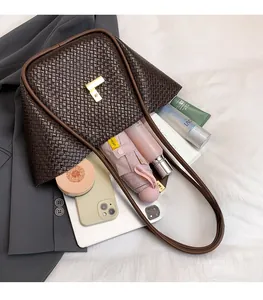 Macro view of dark brown woven tote bag showing large capacity for umbrella and tablet