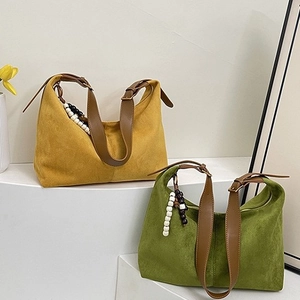 Retro suede shoulder bag with adjustable leather straps in yellow and green colors