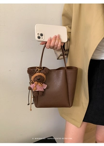 Brown litchi grain leather tote bag with a cute teddy bear charm accessory