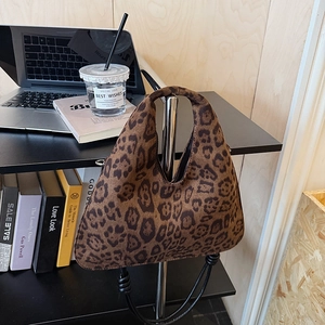 Vintage leopard print suede tote bag in brown and black on a modern display stand