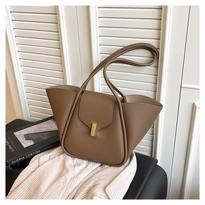 Detail of dark brown lychee leather tote with a rectangular golden buckle lock