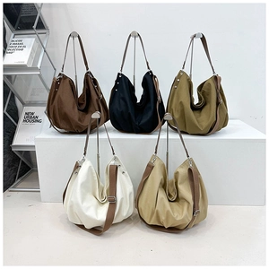 Five minimalist canvas tote bags in earthy tones with brown straps on display