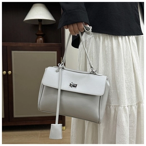 Detail of grey matte leather bucket bag with silver twist lock and minimalist design