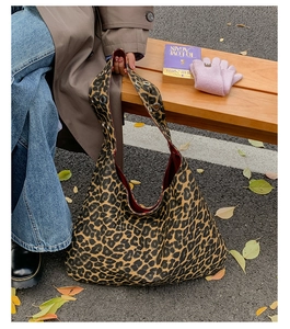 Detail of leopard print hobo tote bag with silver grommets and autumn style