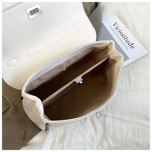 Top view of white bucket bag interior with double compartments and a center zipper pocket