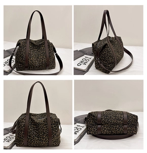 Detail view of leopard print tote bag with brown straps and adjustable shoulder strap