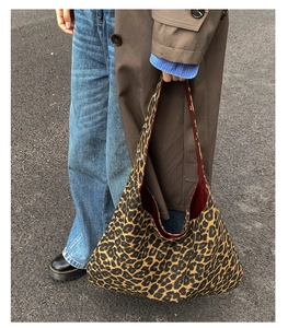 Close-up of leopard print canvas tote bag with burgundy lining and large capacity