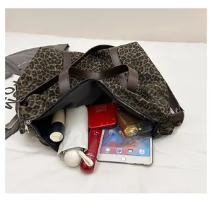 Top view of large leopard tote bag interior showing ample space for daily essentials