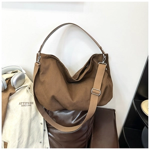 Detail of vintage canvas tote with adjustable wide strap and faux leather handle