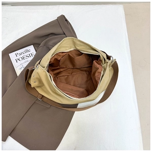 Detail view of the spacious interior with brown lining and secure silver metal zipper