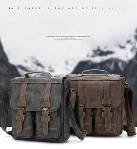 Close-up of vintage leather messenger bags in grey and brown with dual buckles and pockets
