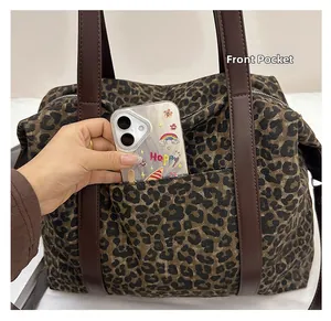 Detail of leopard print tote bag with a practical front pocket for smartphone storage