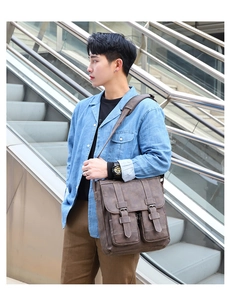 Detail view of a vintage brown messenger bag with dual buckle straps and front pockets