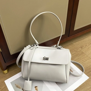Minimalist white leather bucket bag with silver metal buckle and adjustable strap