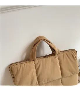 Close-up of padded handle and zipper on the quilted khaki laptop sleeve case