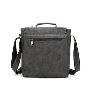 Detail of dark grey retro messenger bag with back zipper pocket and leather handle