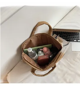 Spacious interior of the brown tote bag showing capacity for tablets and daily items
