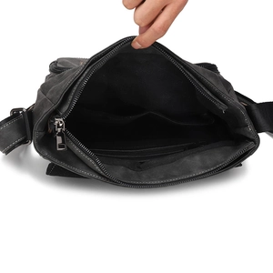 Detail view of the charcoal messenger bag interior with a main compartment and inner pocket