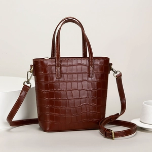Brown crocodile texture bucket bag with dual handles and adjustable shoulder strap