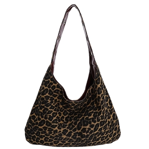 Large leopard print canvas hobo bag with dark brown shoulder strap and metal rivets