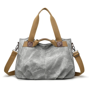 Retro grey canvas tote bag with brown straps and detachable shoulder strap on white backdrop