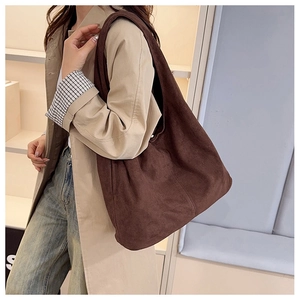 Detail of dark brown faux suede hobo bag showing spacious capacity and soft texture