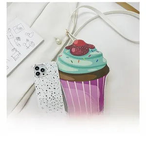 Detail showing the cupcake shoulder bag size compared to a white smartphone