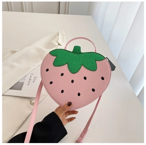 Detailed view of pink strawberry bag with green glitter leaves and detachable strap