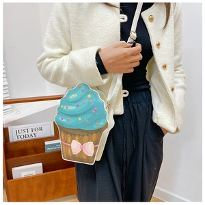Detailed view of creative cupcake crossbody bag with glitter blue cream and pink bow
