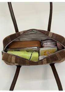 Interior view showing the large capacity and plaid plush texture of the shell tote bag